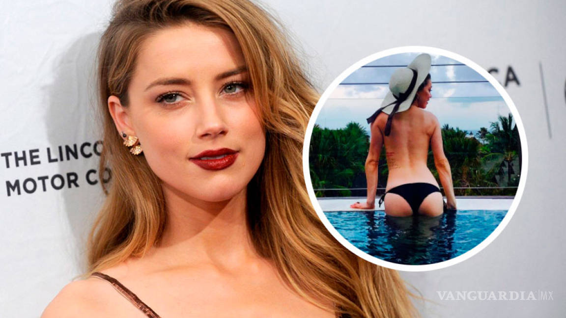 La 'villana' Amber Heard deja ver su sexy espalda