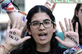 Activistas muestran consignas escritas en sus palmas contra los países contaminantes durante una protesta en el sexto día de la Conferencia de las Naciones Unidas sobre el Cambio Climático (COP28) en Dubai.