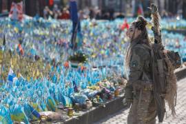 La soldado ucraniana apodada “Bullet” (bala) contempla multitud de banderas de su país que conmemoran los militares caídos, este viernes, Día de la Mujer, en la Plaza de la Independencia, en Kiev.
