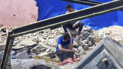 Los palestinos observan la destrucción tras un ataque aéreo israelí en Rafah, Franja de Gaza.
