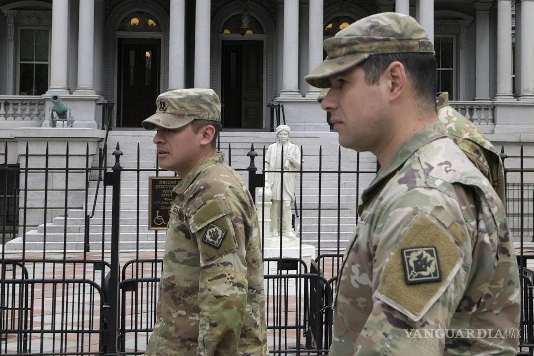 $!Integrantes de la Guardia Nacional de Estados Unidos caminan frente a una estatua de Cristóbal Colón en Washington.