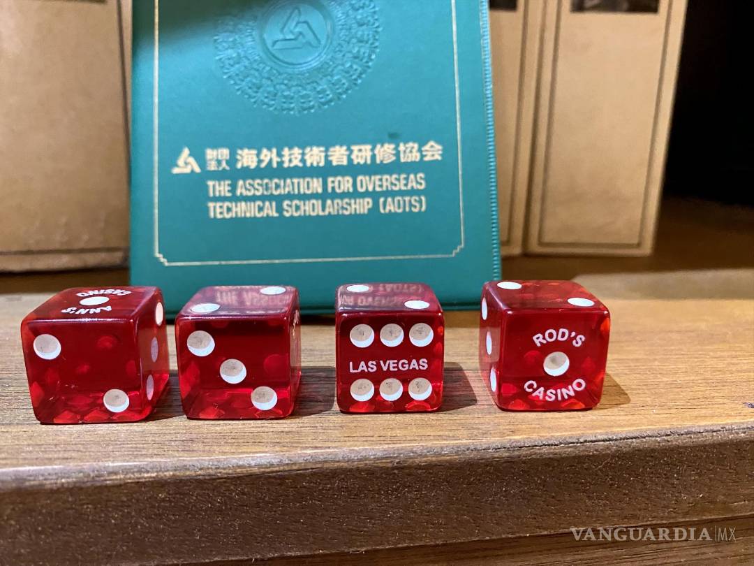 $!Dados de Las Vegas sobre un documento japonés como fondo. Simbología pura.