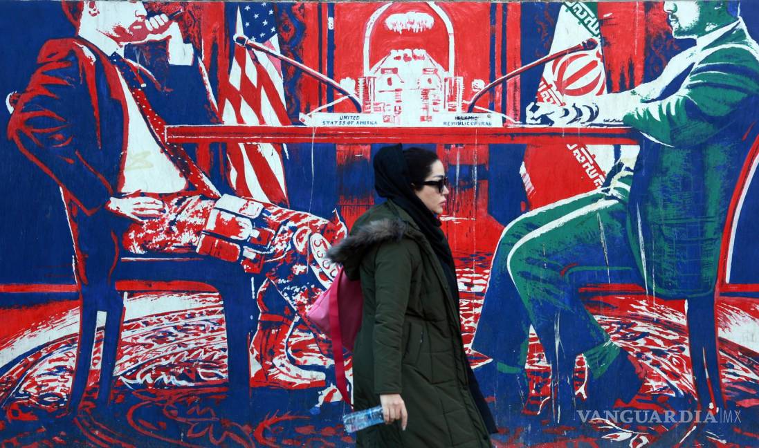 $!Una mujer iraní pasa junto a un mural antiestadounidense cerca de la antigua embajada de Estados Unidos en Teherán.