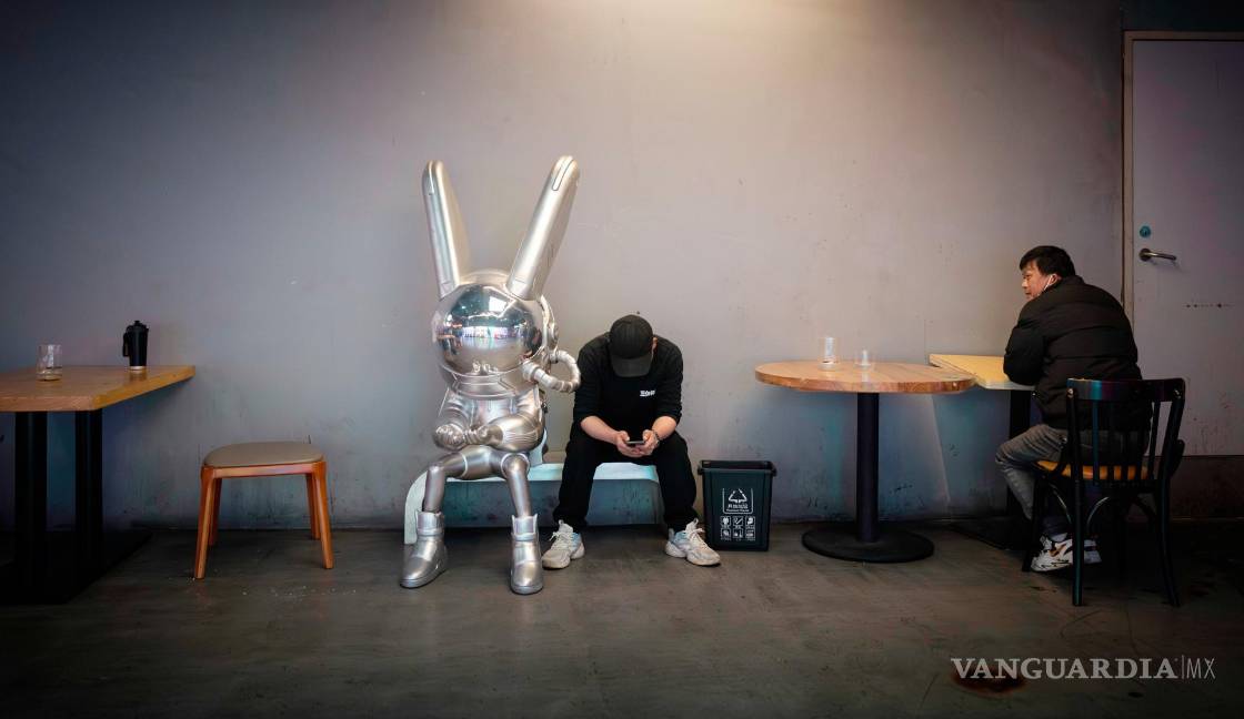 $!Los trabajadores hacen una pausa frente a un restaurante en Shanghái, China.