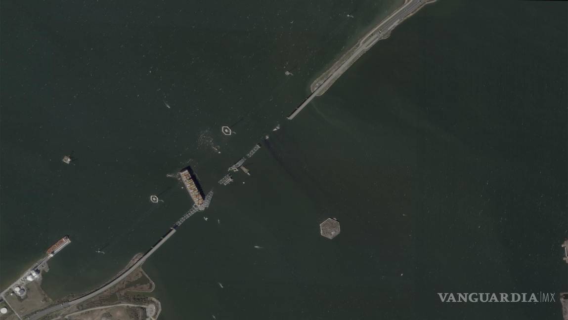 $!This satellite image provided by Planet Labs shows the container ship Dali lodged against the wreckage of the Francis Scott Key Bridge, Friday, March 29, 2024, in Baltimore, Md. (Planet Labs via AP)