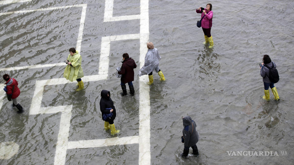 Turistas en las aceras de una Venecia totalmente inundada