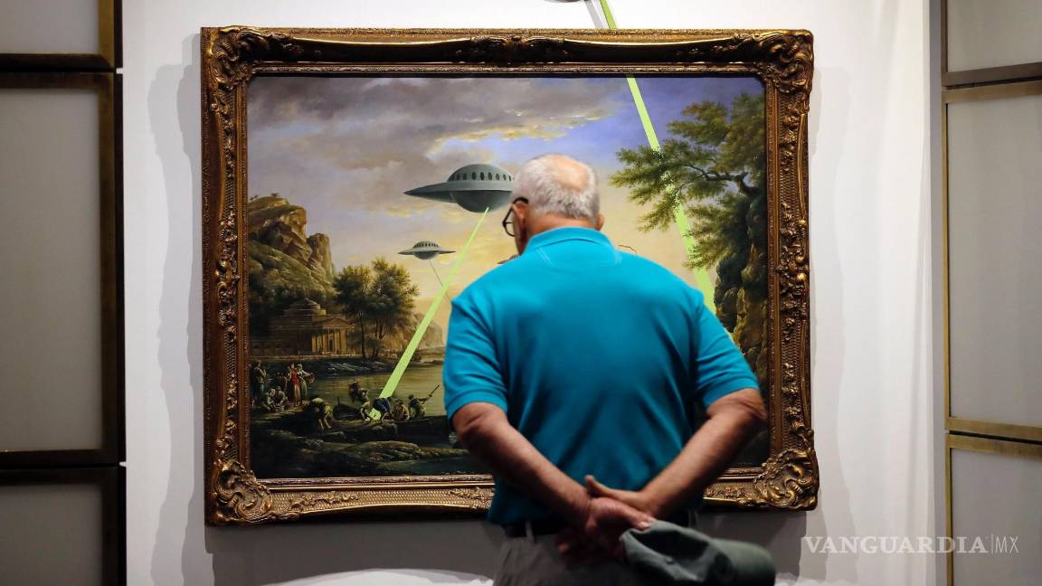 $!Una persona observa el cuadro 'UFO' (OVNI) por el artista británico Banksy durante la exposición 'El Arte de Banksy' en Berlín, Alemania, el 20 de junio de 2017.