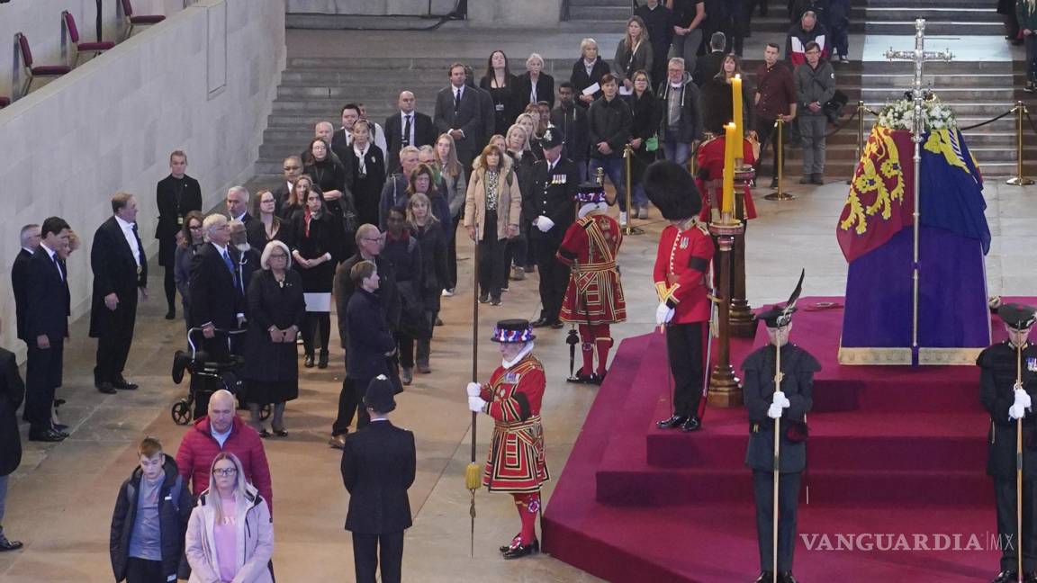 $!El primer ministro de Canadá, Justin Trudeau, a la izquierda del muro, y miembros del público en fila frente al ataúd de la reina Isabel II en el Palacio de Westminster.