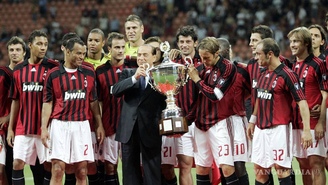$!FILE - AC Milan president Silvio Berlusconi, center in dark suit, celebrates with the team after defeating Juventus to win the Luigi Berlusconi Trophy exhibition soccer match at the San Siro stadium in Milan, Italy, on Aug. 17, 2007. Berlusconi, the boastful billionaire media mogul who was Italy's longest-serving premier despite scandals over his sex-fueled parties and allegations of corruption, died, according to Italian media. He was 86. (AP Photo/Alberto Pellaschiar, File)