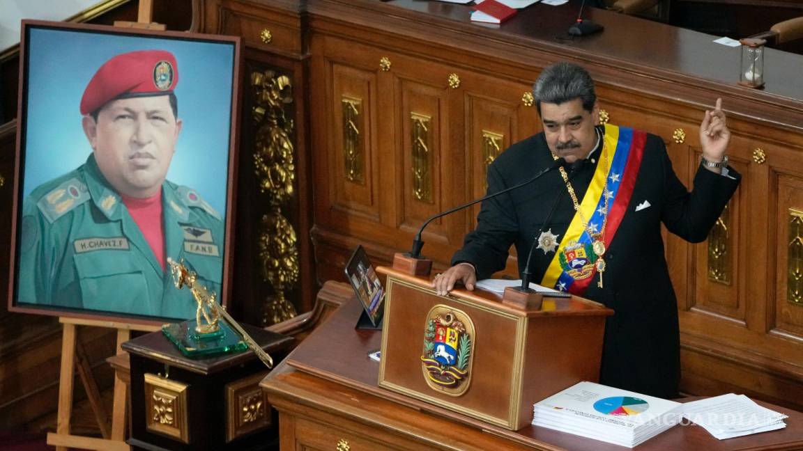 $!Junto a un retrato del fallecido presidente Hugo Chávez, el presidente venezolano Nicolás Maduro pronuncia su discurso ante legisladores en la Asamblea Nacional.