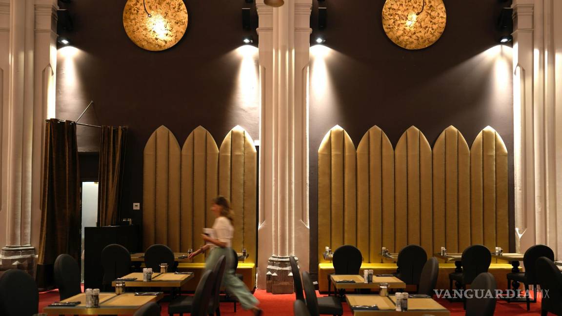 $!Una mujer camina por el comedor del hotel Martin’s Patershof en el centro de Mechelen, Bélgica.