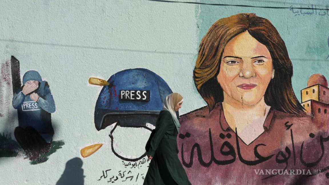 $![ARCHIVO - Un mural de la periodista asesinada de Al Jazeera, Shireen Abu Akleh, que fue baleada]