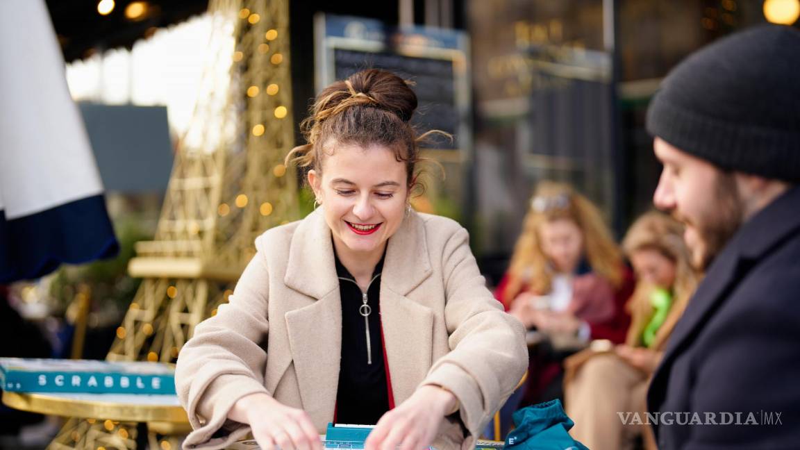 $!Chloe M jugando al Scrabble en café de París.