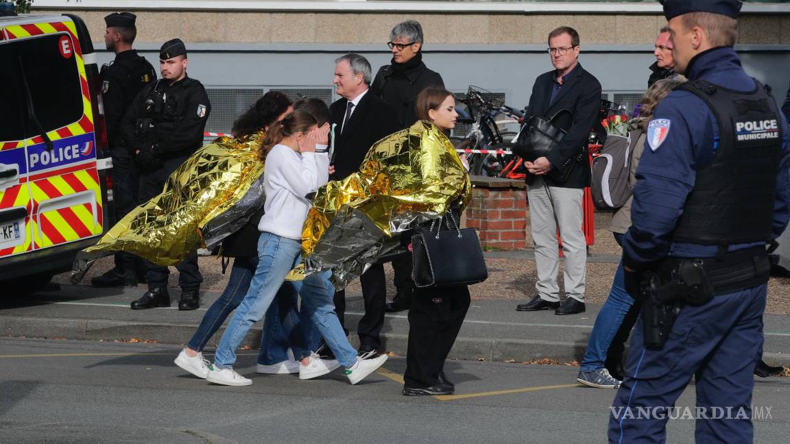$!Policías escoltan a niños ante la escuela Gambetta durante una amenaza de bomba el lunes 16 de octubre de 2023 en Arras, en el norte de Francia.