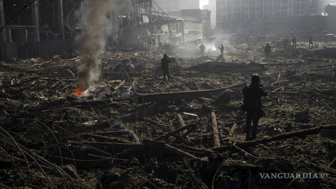 $!Gente reunida entre los restos de un ataque a un centro comercial en Kiev, Ucrania. AP/Rodrigo Abd