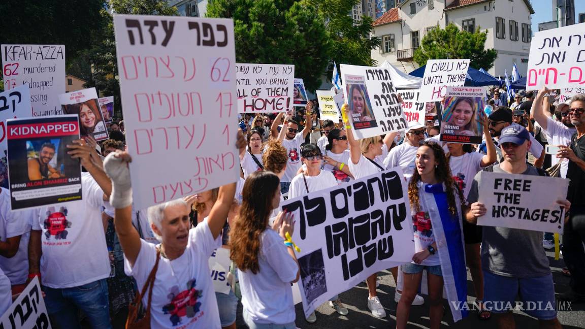 $!Residentes del kibutz Kfar Azza atacada por Hamás, sostienen fotografías de sus seres queridos, piden el regreso de más de 220 rehenes, en Tel Aviv, Israel.