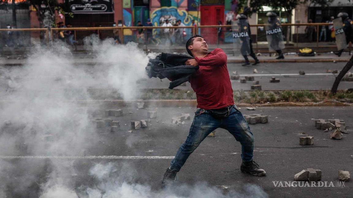 $!Manifestantes que respaldan al destituido presidente Pedro Castillo enfrentan a la Policía a las afueras de la Prefectura de Lima.