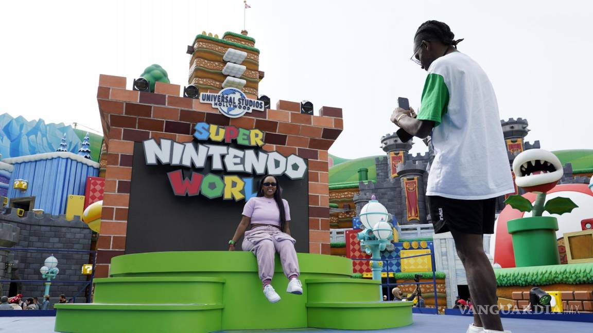 $!Charles Brockman, right, of Austin, TX, takes a picture of Melissa Baker in the main plaza of the new Universal Studios Hollywood attraction Super Nintendo World during a preview day, Thursday, Feb. 16, 2023, in Universal City, Calif. The attraction opens to the public Friday. (AP Photo/Chris Pizzello)