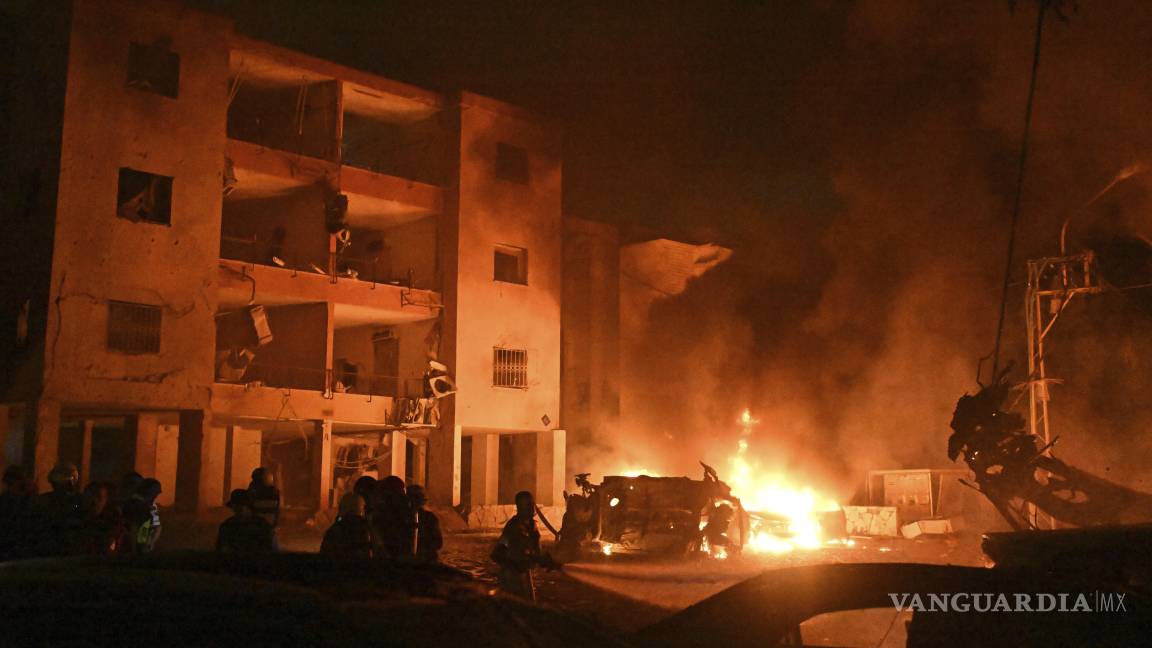 $!Los bomberos trabajan para extinguir un incendio después de que un misil lanzado desde Irán impactara Haifa, en el norte de Israel.