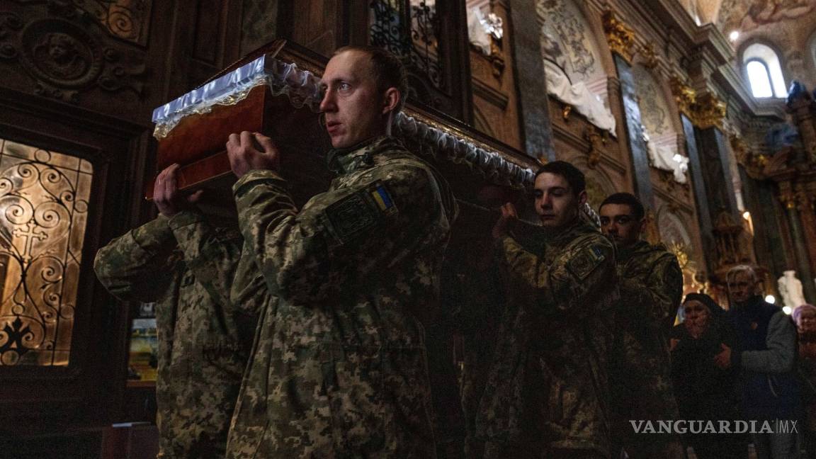 $!La madre del teniente Oliynyk Dmytro, de 40 años, que murió en combate, llora su muerte mientras camina tras el ataúd en su funeral.