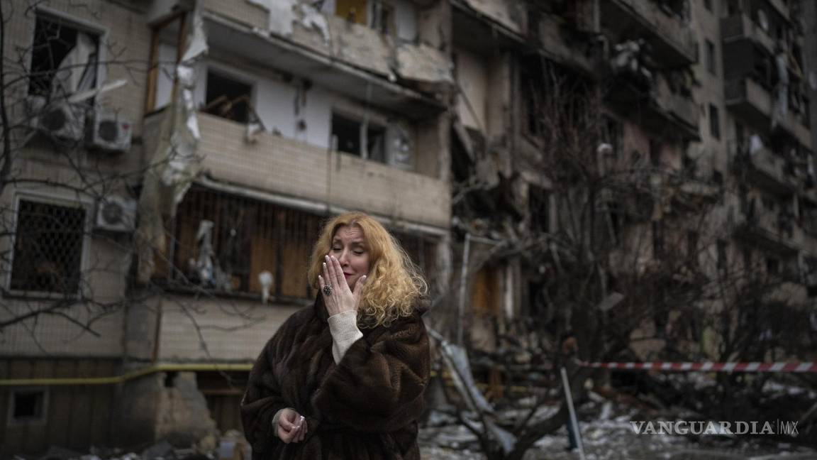 $!Natali Sevriukova llora frente a su edificio de apartamentos destruido en un ataque con cohetes en Kiev, Ucrania, el 25 de febrero de 2022.