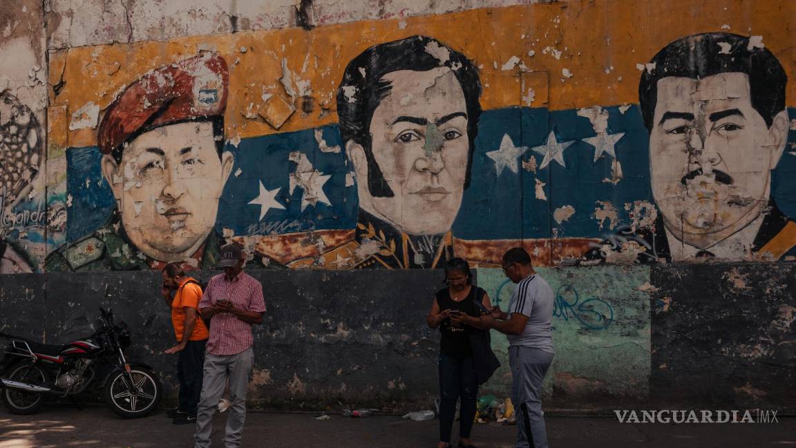 $!Mural de Hugo Chávez, Simón Bolívar y Nicolás Maduro cerca de un centro electoral de votación en las elecciones presidenciales en Petare, Venezuela.