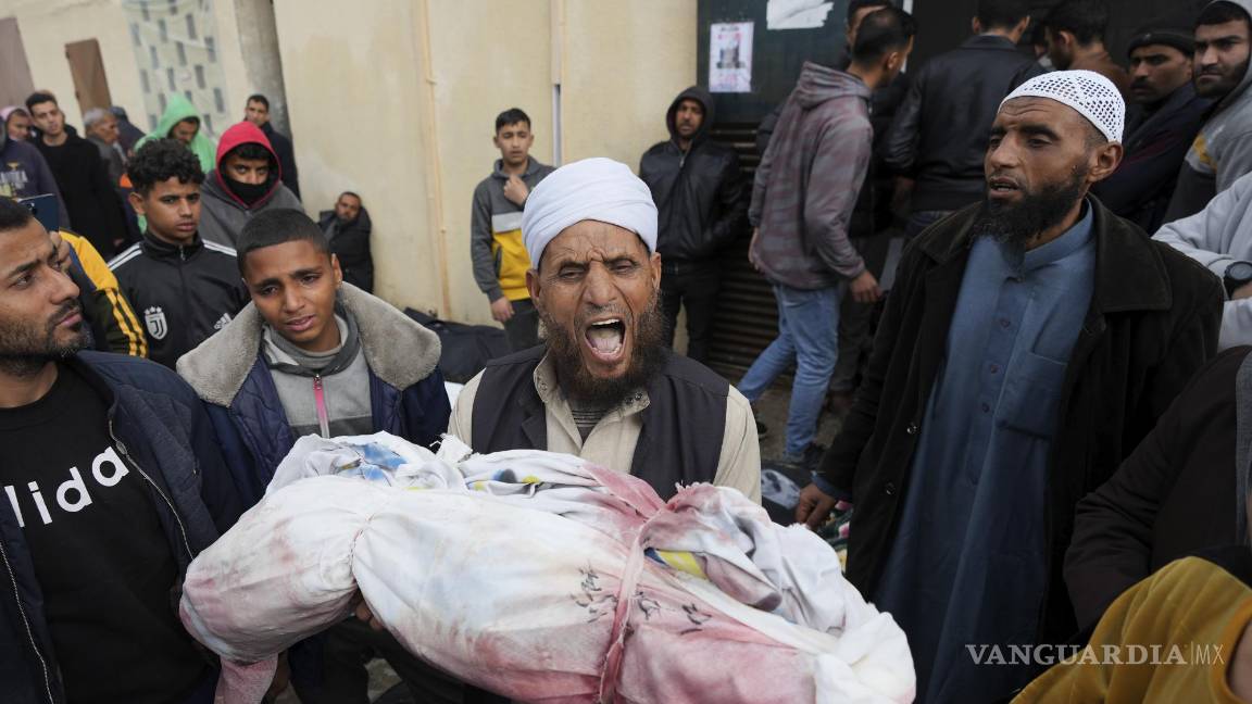 $!Un hombre llora al sostener en sus brazos el cuerpo de un niño fallecido tras los ataques israelíes.