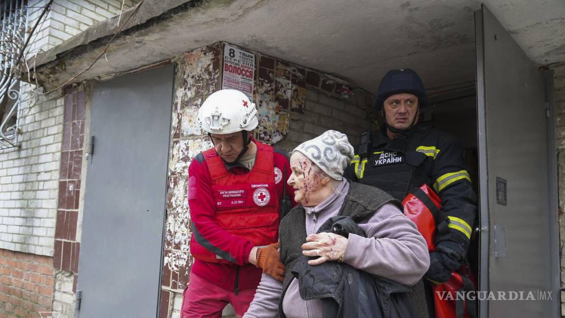 $!En la imagen, una anciana siendo evacuada del lugar del impacto de un cohete en una zona residencial de Sumy, Ucrania.