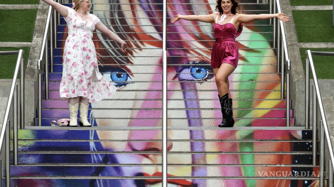 $!Dos fanáticas de Taylor Swift frente a un mural afuera del estadio de Wembley antes del primero de los conciertos del Eras Tour en el estadio de Wembley.