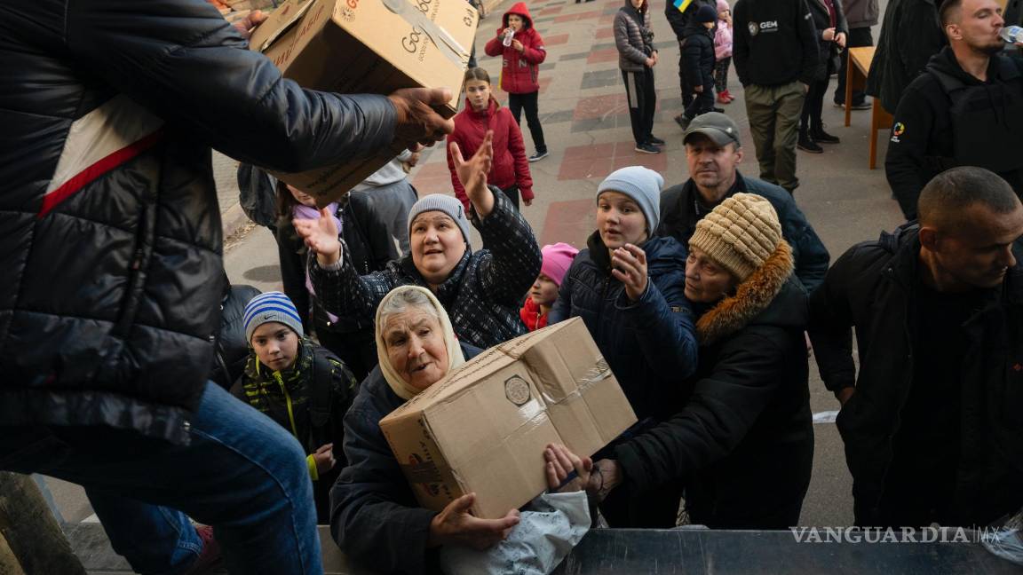 $!Los residentes reciben ayuda tras la retirada de las fuerzas rusas de la zona, en Kherson, Ucrania.
