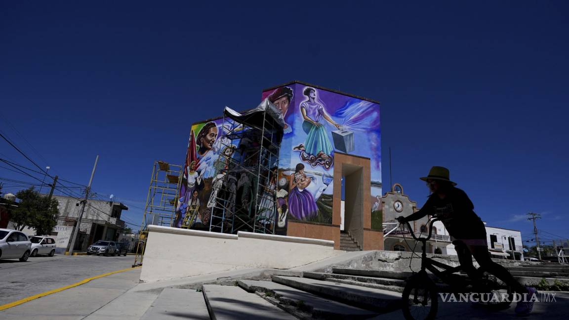 $!Una peatona monta su bicicleta frente a un mural pintado por el artista mexicano Jesús Rodríguez, en San Salvador, estado de Hidalgo (México)