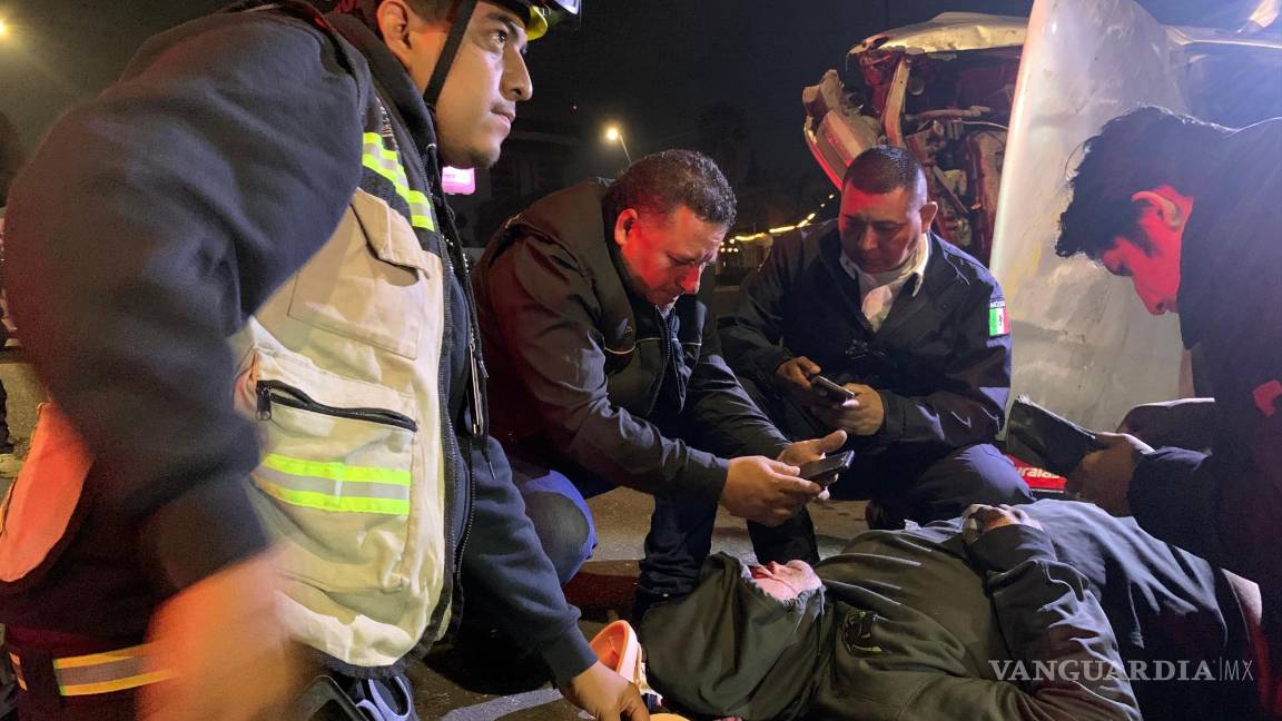 $!Paramédicos y automovilistas auxilian al conductor tras el aparatoso accidente en el bulevar Fundadores, donde el vehículo volcó tras impactarse con los muros de concreto.