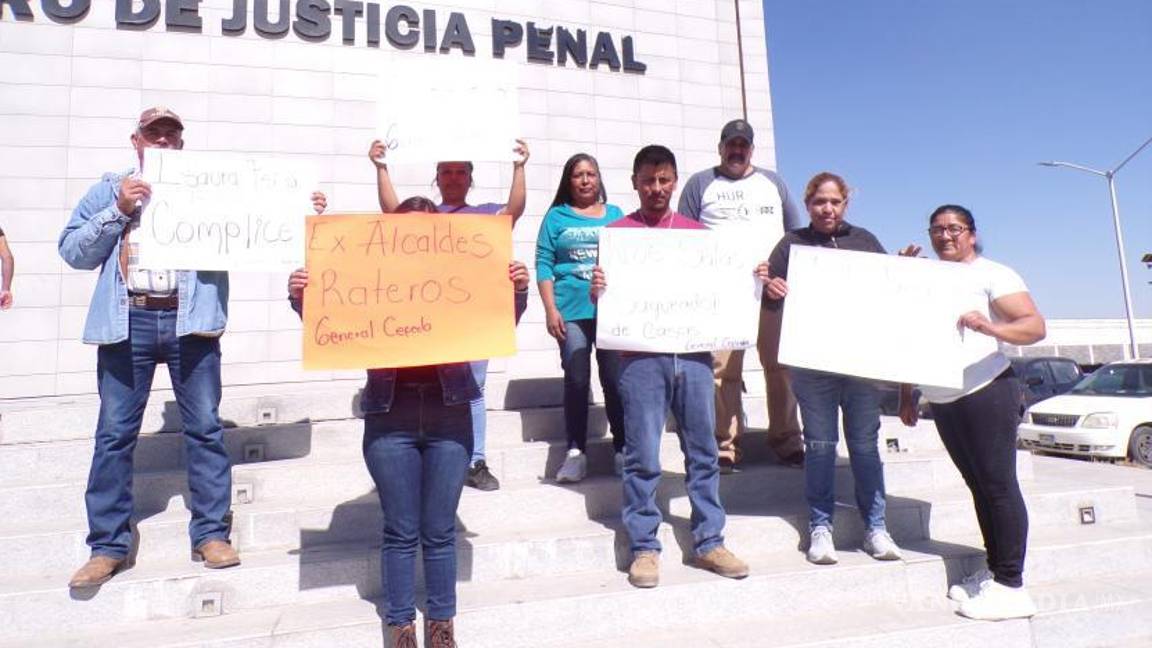 $!Manifestantes portan pancartas exigiendo justicia en el caso de despojo de viviendas.