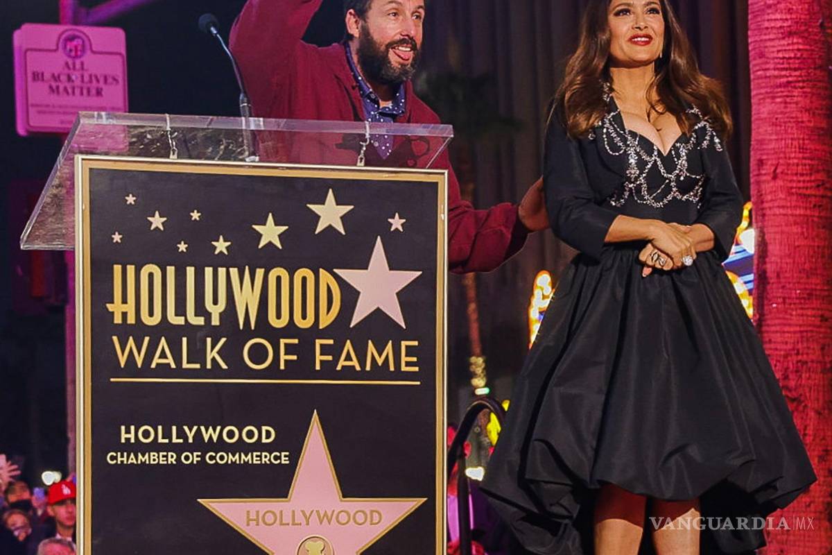 $!El actor Adam Sandler pronuncia unas palabras en nombre de la actriz Salma Hayek antes de recibir la estrella en el Paseo de la Fama en Hollywood (EU). EFE/Phillip Kim