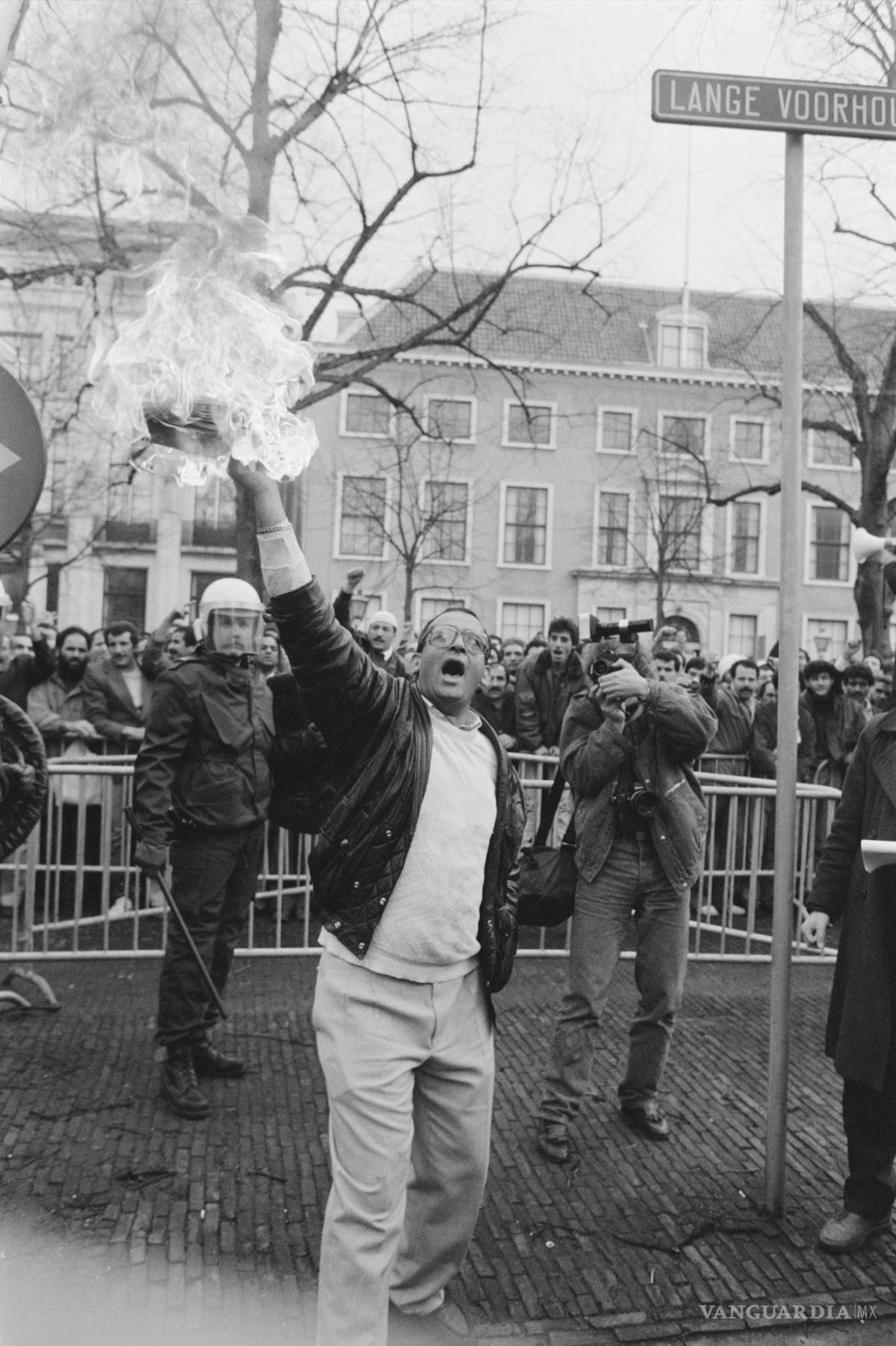 $!Manifestantes quemando libros de Rushdie