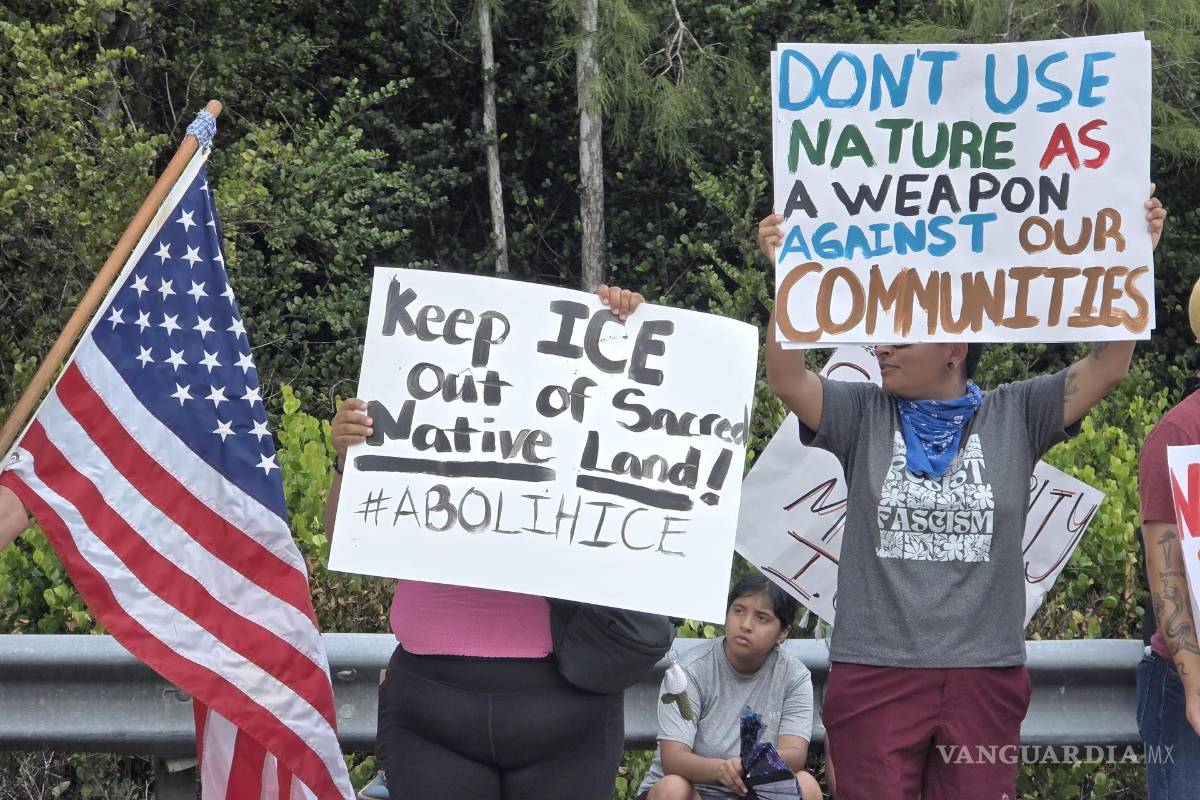 $!Personas sostienen carteles durante una protesta junto al centro de detención para migrantes 'Alligator Alcatraz'.
