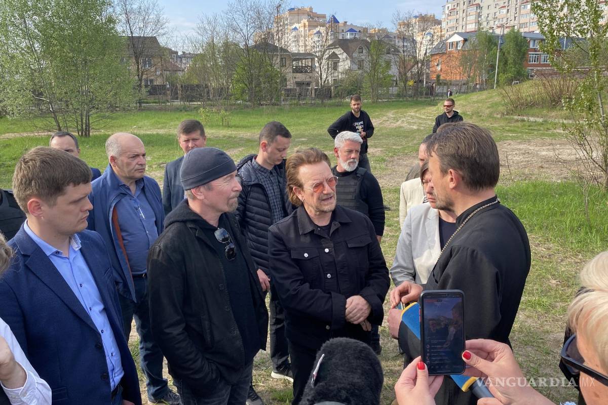 $!El músico irlandés de la banda U2, Bono (c), este domingo en la localidad ucraniana de Borodynka.