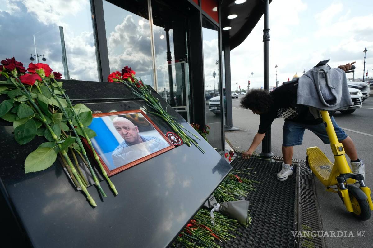 $!Un hombre coloca flores en un monumento en un café propiedad de Yevgeny Prigozhin, jefe de la compañía militar Wagner Group en San Petersburgo, Rusia.