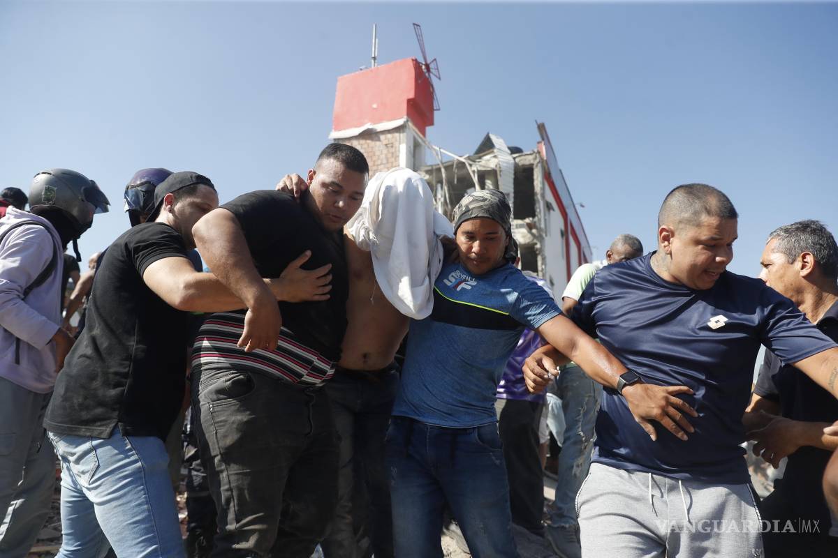 $!CALI (COLOMBIA), 10/08/2026.- Personas son evacuadas de un edificio colapsado este lunes, en Cali (Colombia). Al menos 20 edificios sufrieron graves daños por consecuencia del terremoto de magnitud 7,4 que sacudió la mayor parte del país, con epicentro en la zona del Pacífico.
