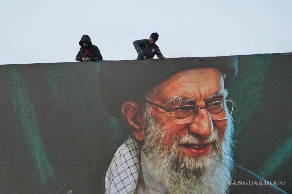 $!Trabajadores instalan una valla publicitaria en un paso elevado con un retrato del difunto líder supremo iraní, el ayatolá Ali Khamenei en Teherán, Irán.