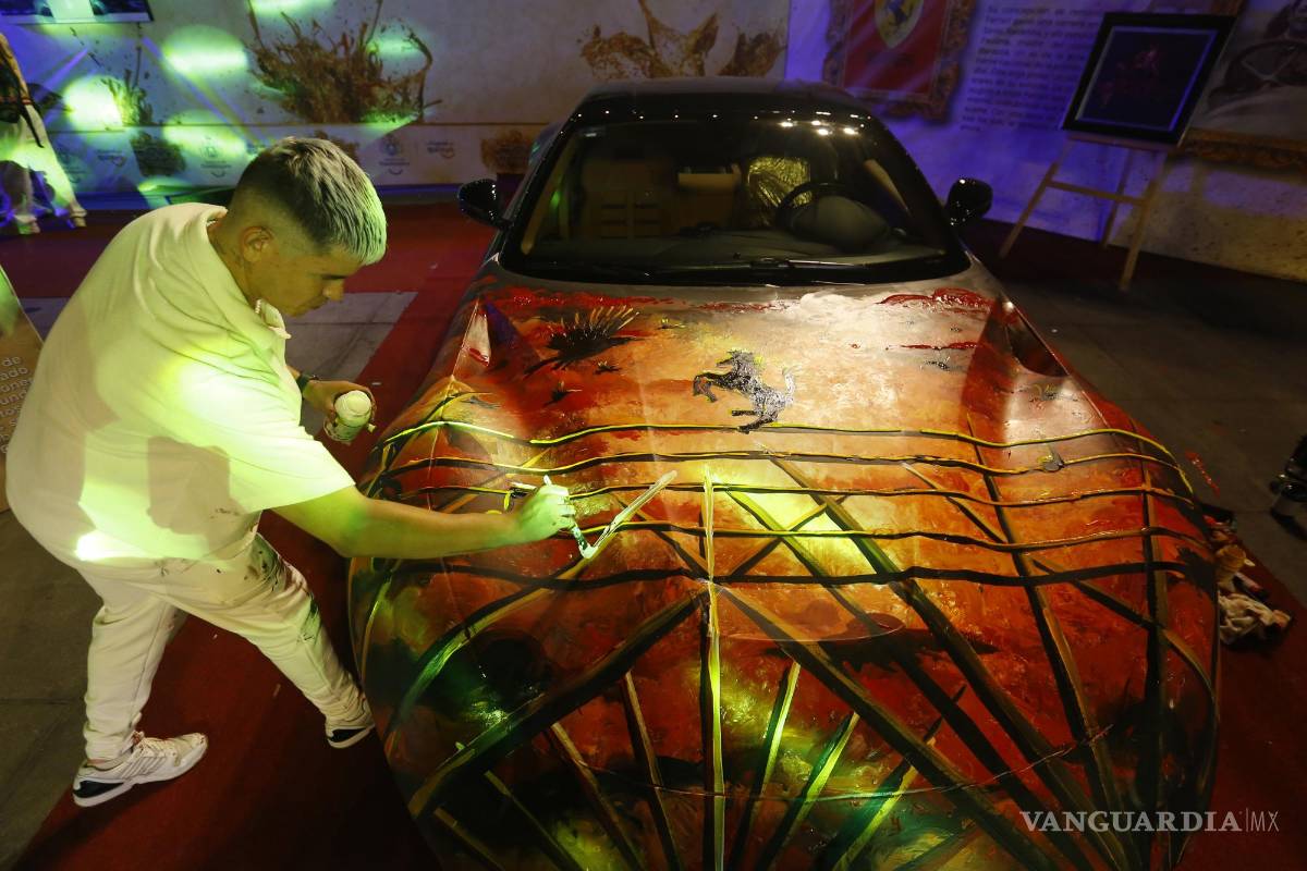 $!Un artista decora un auto Ferrari en el marco del Autoart World, en Guadalajara (México).