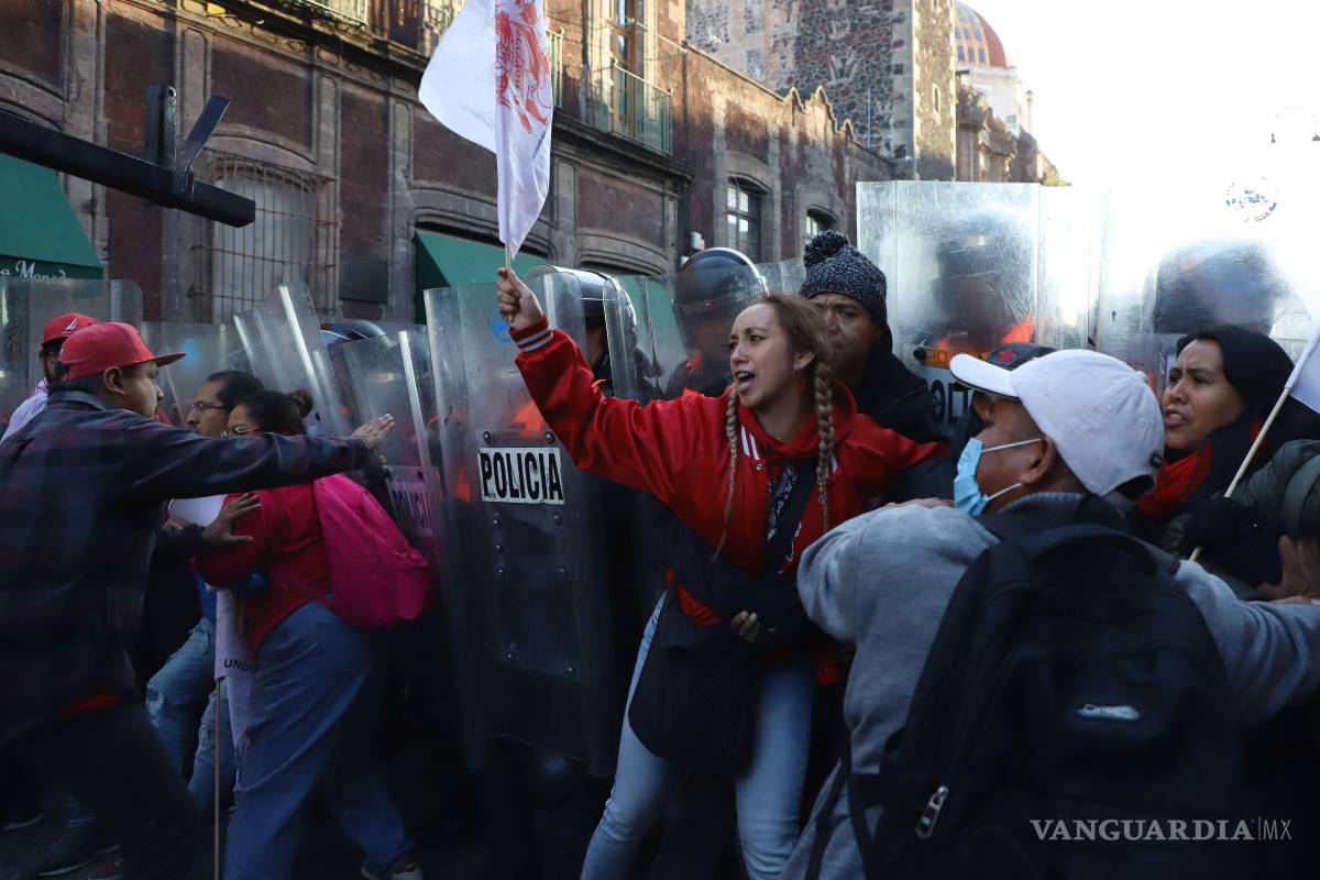 $!Integrantes de la CNTE intentaron derribar una de las vallas que protegían los accesos a Palacio Nacional lo que provocó una confrontación con la policía.