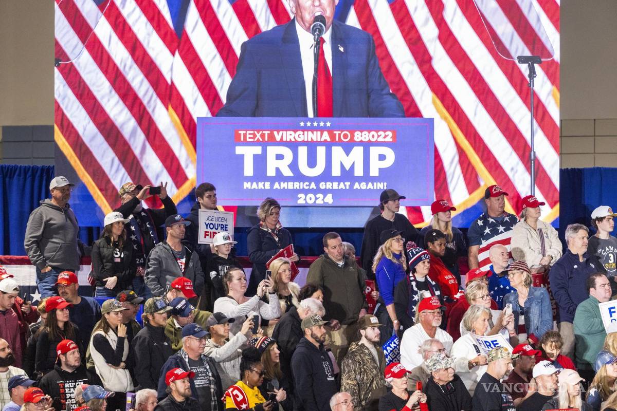 $!Partidarios escuchan a Donald Trump mientras le ven en un monitor mientras habla durante un mitin de campaña del Súper Martes en Richmond, Virginia.