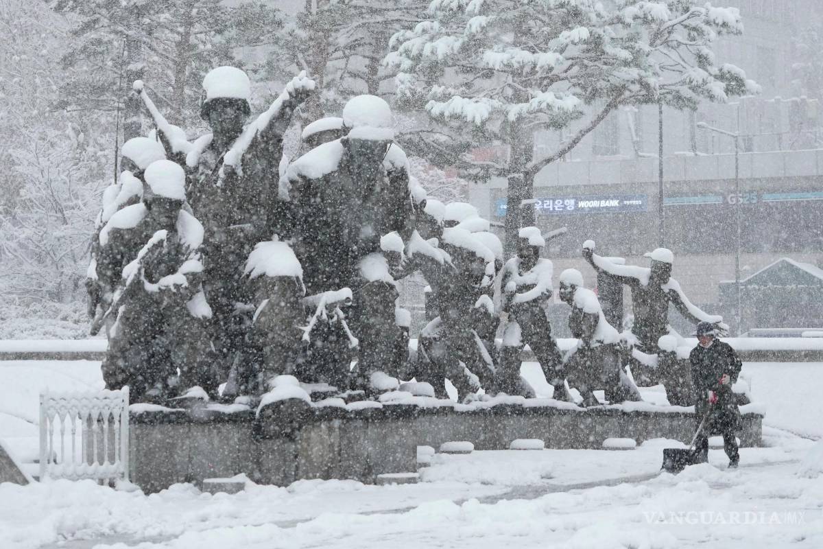 $!Un trabajador quita nieve con una pala cerca de un monumento en recuerdo de la Guerra de Corea en el Museo Memorial de la Guerra de Corea en Seúl.