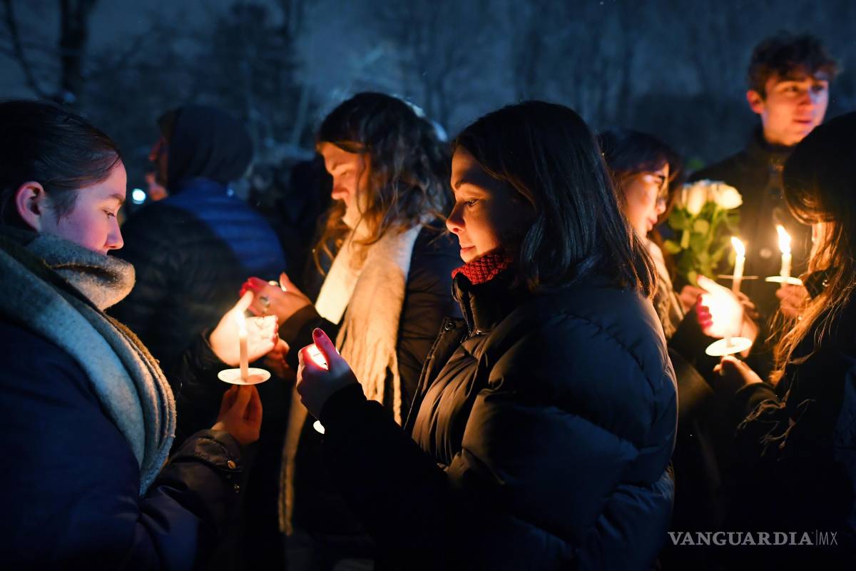 $!Personas sostienen velas durante una vigilia en Providence, Rhode Island, en memoria de las víctimas del tiroteo en el campus de la Universidad de Brown.