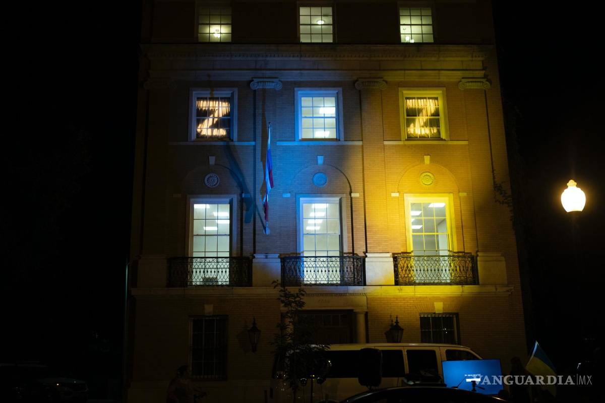 $!El personal de la embajada rusa muestra la letra “Z” en sus ventanas mientras los manifestantes proyectan los colores de la bandera de Ucrania en el edificio.