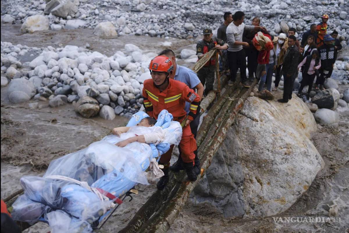 $!Rescatistas trasladan a los sobrevivientes a través de un río luego de un terremoto en la ciudad de Moxi del condado de Luding, en la provincia de Sichuan.