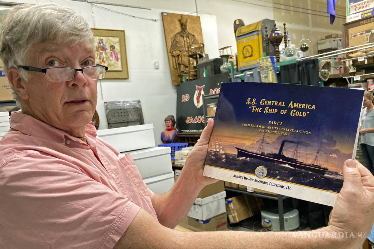 $!Fred Holabird, president of Holabird Western Americana Collections, poses with a catalog of Gold Rush-era collectibles recovered from the 1857 shipwreck of the S.S. Central America in a storage room at his office in Reno, Nev., on Friday, Nov. 25, 2022. Items from the shipwreck will be offered for public sale at the first of two public auctions on Dec. 3 in Reno. (AP Photo/Scott Sonner)