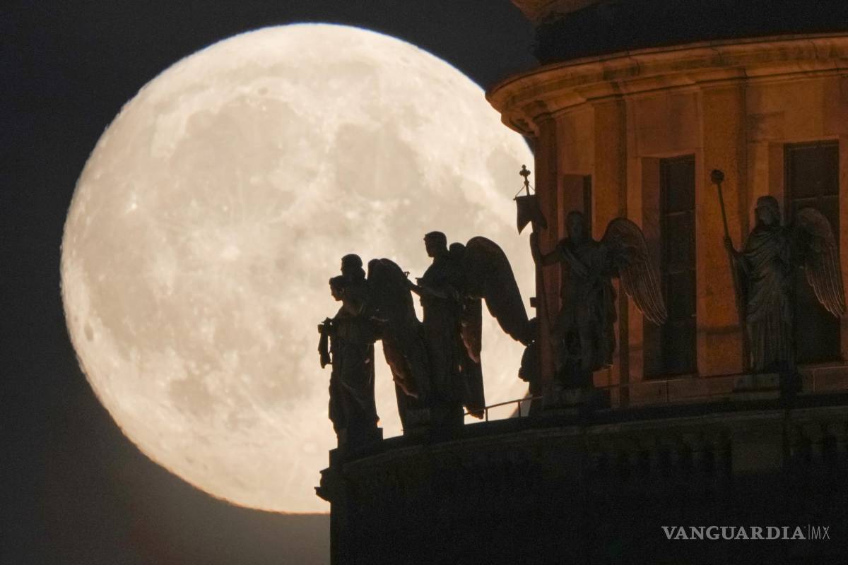 $!Esculturas de ángeles fijados en la Catedral de San Isaak se recortan en la luna llena en San Petersburgo, Rusia.