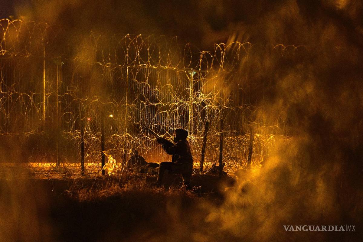 $!Un hombre intenta hacer un agujero en la valla construida a lo largo de la frontera entre Estados Unidos y México en Ciudad Juárez, México, el 4 de junio de 2024.